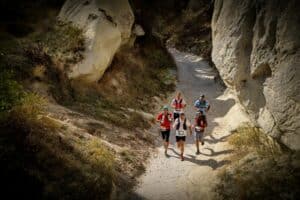 People Running on Dirt Road, trail runners