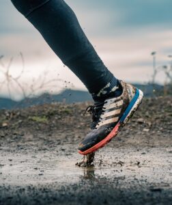 a person walking in a puddle of water