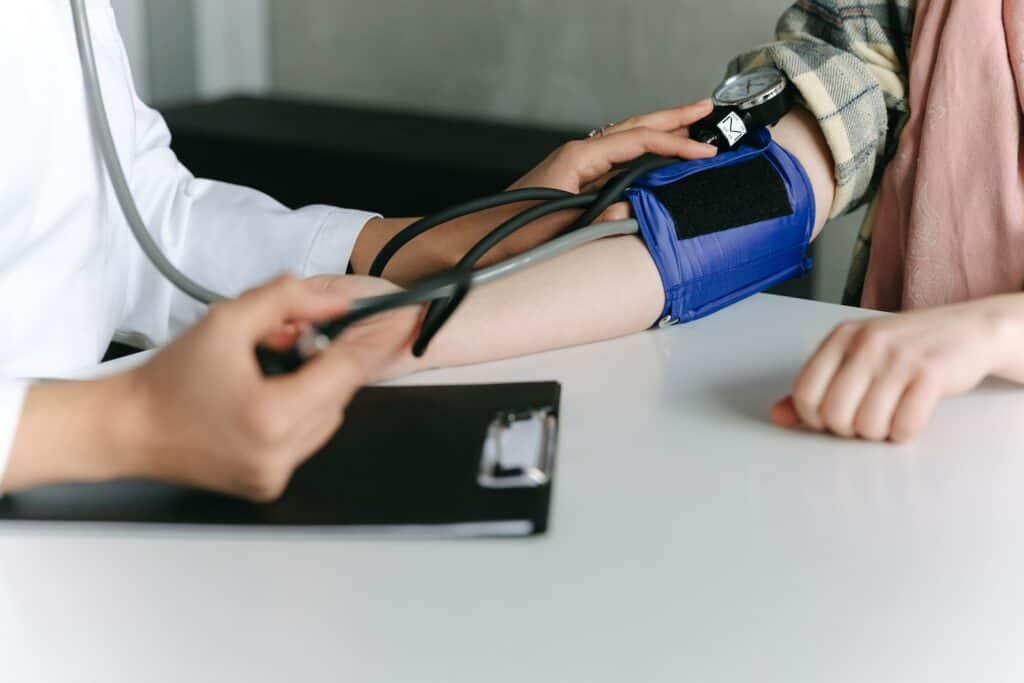 A Healthcare Worker Measuring a Patient's Blood Pressure Using a Sphygmomanometer