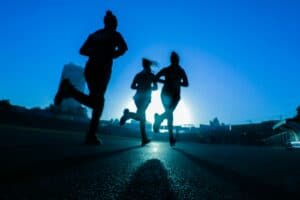 silhouette of three women running