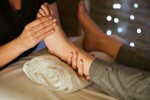 therapist massaging foot of client