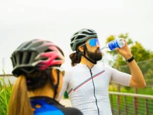 a man with a beard drinking water from a bottle