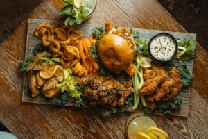 a wooden table topped with a plate of food